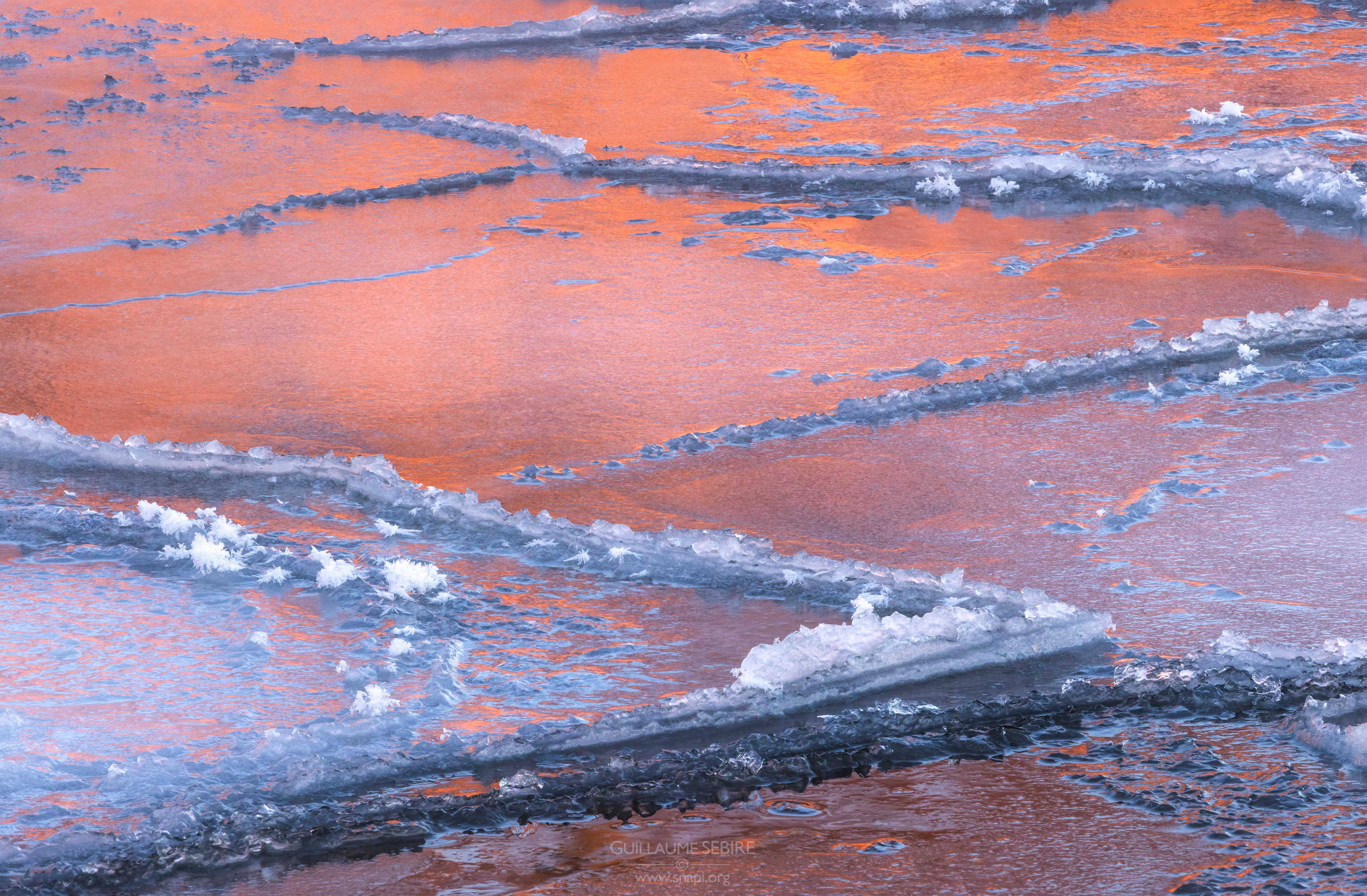 Winter abstract on the Baltic Sea - reeds reflection at sunset, Helsinki, Finland